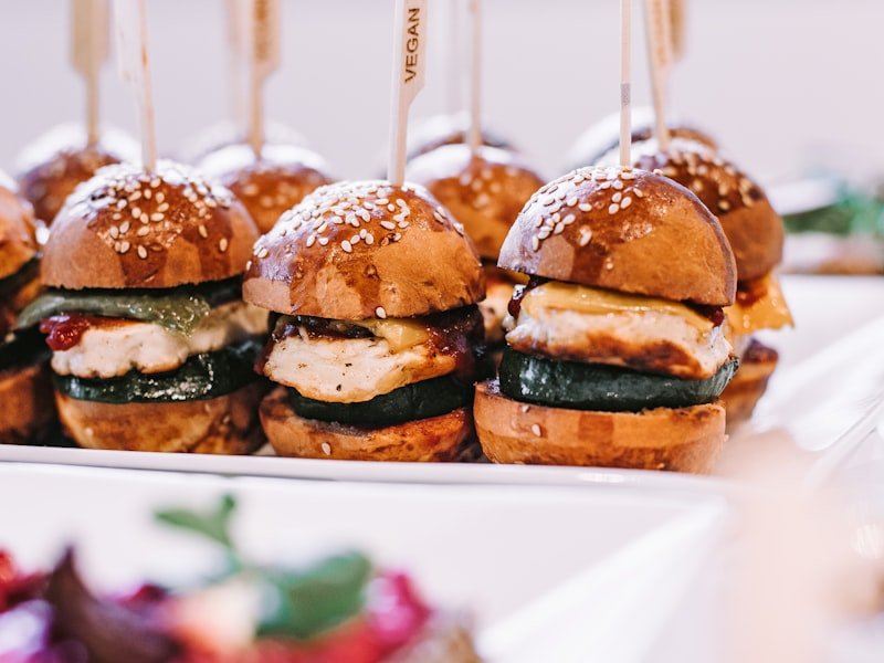 A row of canapés and hors d'oeuvres plated for a cocktail reception