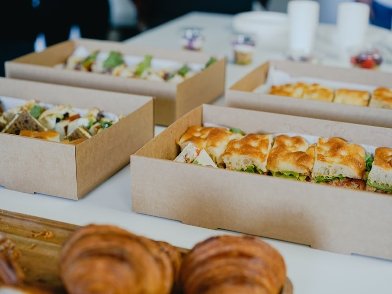 Boxed sandwiches and pastries prepared for drop-off catering