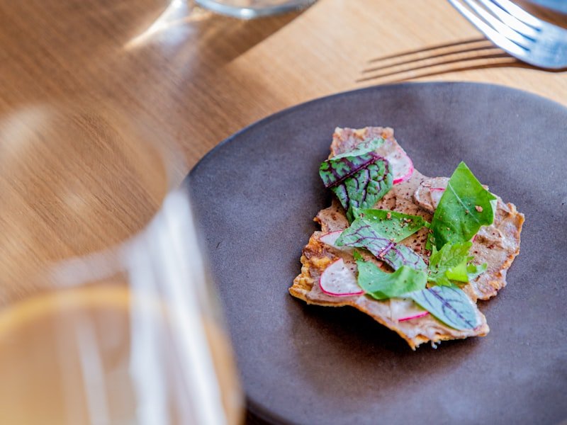 An intimate plated dinner with a glass of wine for an in-home event